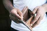 A man opening an empty wallet