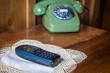 Cordless phone and vintage rotary phone side by side on a table — symbolizing memory, trauma, and healing in EMDR therapy in this story.