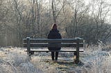 Person sitting alone on a bench