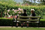 Two older women on park bench
