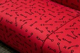 red fabric with a set of football play symbols