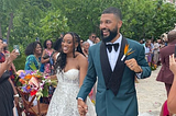 Stef and Maritza, walking down the aisle, surrounded by loved ones on their wedding day.