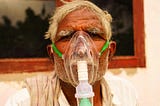 indian man with oxygen mask