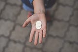 Person holding 2 coins