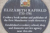 Bronze circular plaque with colourful coat of arms at head and details of Elizabeth Raffald printed in white.