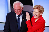 Photo of Senators Bernie Sanders and Elizabeth Warren smiling together before the July 30, 2019 Democratic primary debate.