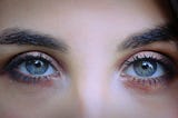 A close-up of a woman’s beautiful blue eyes