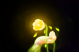 Girl holding out her palm with a glowing yellow rose floating above it against a black background.