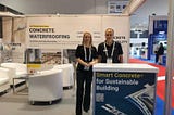 Two Kryton representatives are standing in the middle of a Kryton booth as part of the many construction industry events Kryton attends.