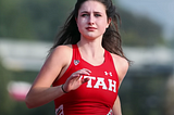 Lauren McCluskey running in her track and field uniform.