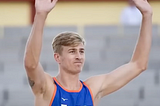 Netherlands’ Steven Van de Velde holds up his hands at a beach volleyball venue.