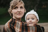 chubby cheeked baby girl and her mother wrapped in warmth