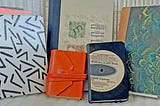 A collection of hardback journals with various covers and makes