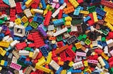 Multi-colored Lego pieces lying one on top of another.