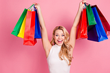 blonde girl holding up shopping bags