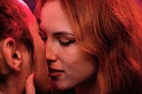 A woman kissing a man