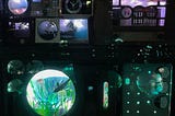 An image from Meow Wolf’s Convergence Station in Denver, Colorado, of a wall of vaguely technical-looking gadgets and readouts from the 1970s, including meters with needles, clocks, a mini-diorama, and a small artificial aquarium.