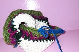 An indescribable crocheted object, with different colours defining concentric rows of a twisted 5 D base