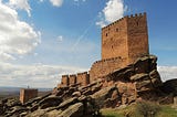 A castle with a blue sky in the background