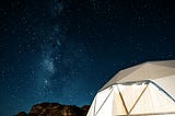 Geodesic dome shelter under a brilliant, starry, night sky. New perspectives. Connectedness. Universe.