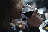 Woman drinking a glass of Merlot.