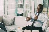 A man in a tie giving a thumb’s up to a phone. You only need to prove yourself to yourself
