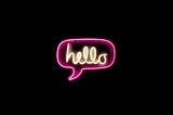 The word “hello” in a speech bubble in neon.