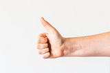 person right hand doing thumbs up