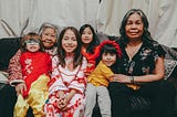 The women of a family sitting together, posing for a photo