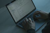 Person typing code on his MacBook