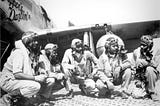 Five Tuskegee Airmen pilots in front of an airplane wing in 1942. Photo from U.S. Air Force.