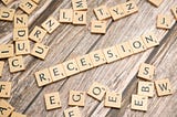 Scrabble tiles spell out the word “RECESSION.”
