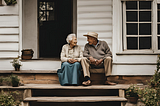Old couple sitting on front porch