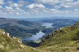 View from Ben Venue, Trossachs, Scotland, overlooking Loch Venachar with Stirling in the far distance.