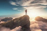 Image of a man standing facing the sun in the horizons.