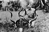 Black-and-white photo of a young Ernest Hemingway in Africa in 1934