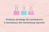 pink background with 3 paperclips and text saying content strategy for marketers