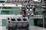 3D printing machine creating an engine part