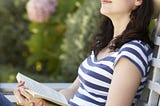 Woman relaxed on bench in garden