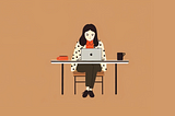 A designer working on her computer while sitting at the desk with a cup of coffee.