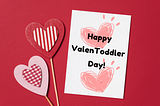 White card on a red background with hearts that reads “Happy ValenToddler Day!”