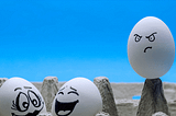 two eggs having fun while one is envious