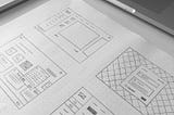 4 hand drawn wireframes in a white dotted paper