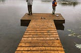 Two friends fishing from the dock