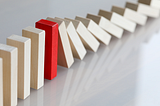 wooden dominoes shown in the midst of falling.