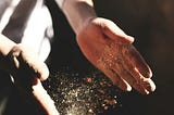 Person’s hands with flour.