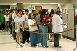 Large group of people wait in line to get assistance with the California EDD claim.