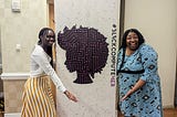 a sign with the logo of blackcomputeHER with a black woman on each side