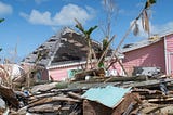 In The Bahamas a pink house and a pile of construction rubble stands in ruin after being hit by hurricane Dorian.