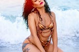A beautiful woman lays on beach
